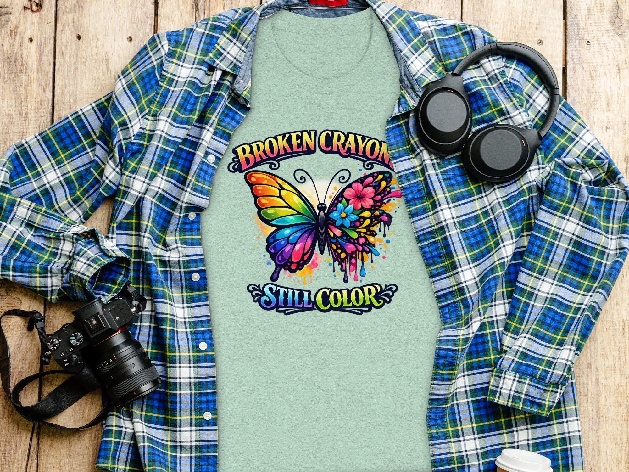 Light green t-shirt with rainbow butterfly and text "Broken Crayon Still Color."