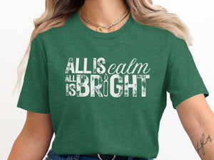 Green t-shirt with "All is calm, all is bright" text and candle graphic.