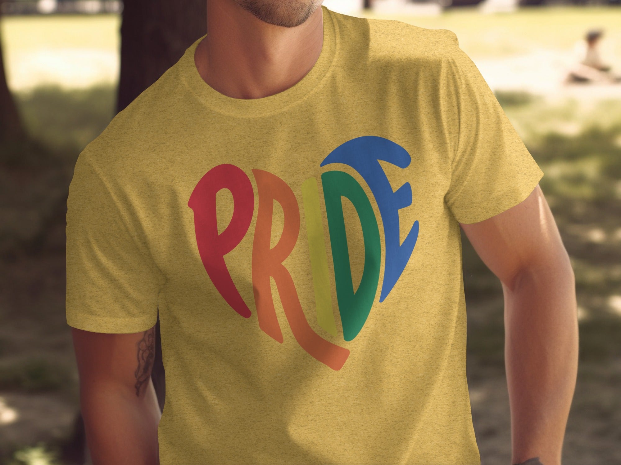 Yellow t-shirt with rainbow heart graphic spelling "PRIDE"
