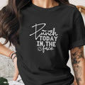 Black t-shirt with white text that says "Punch TODAY IN THE face" with a smiley face.
