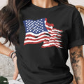 Black t-shirt with a distressed American flag graphic and floral arm tattoo.