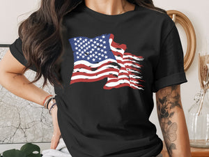 Black t-shirt with a distressed American flag graphic and floral arm tattoo.
