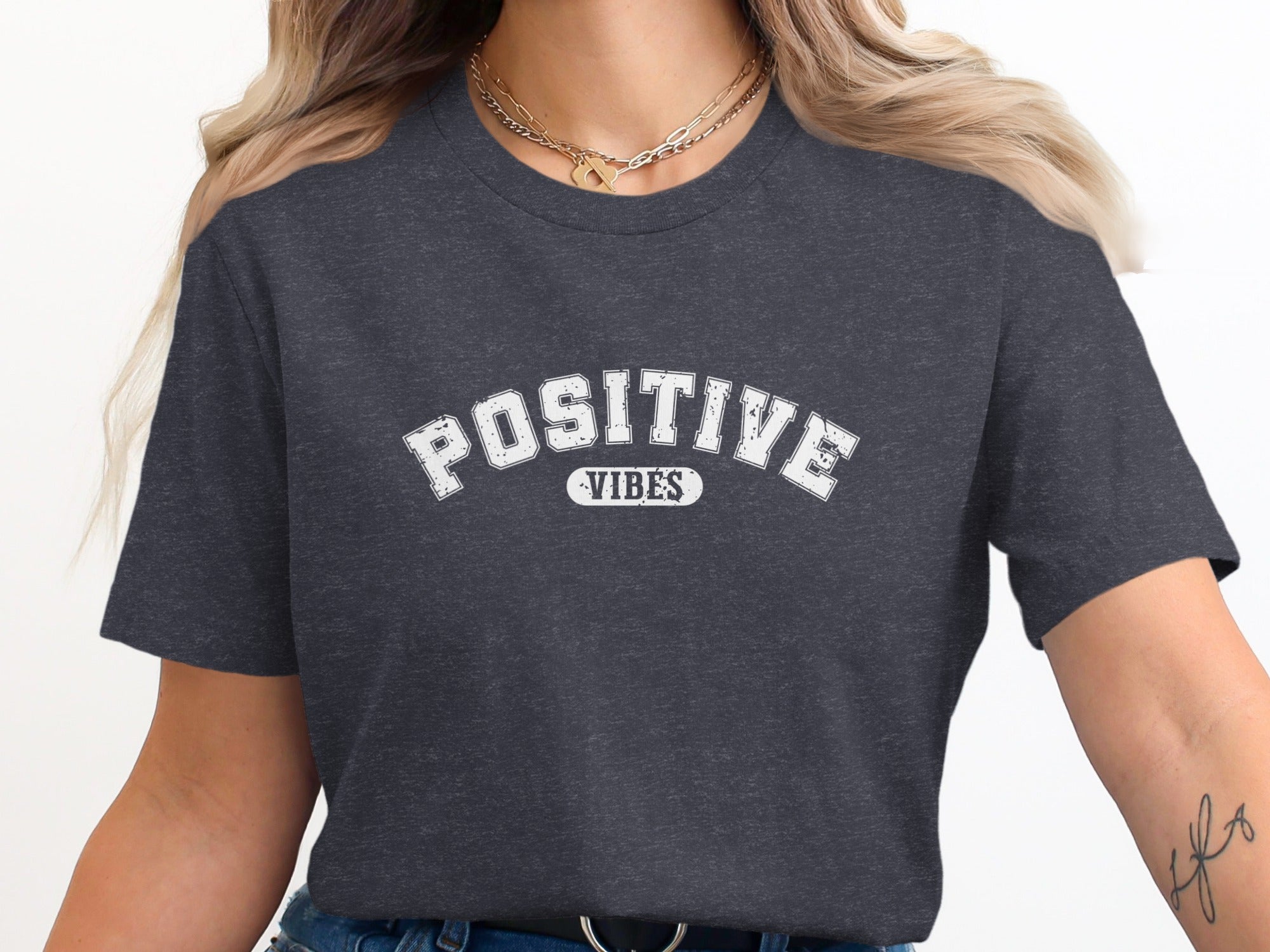 Dark charcoal t-shirt with white text reading "POSITIVE VIBES".