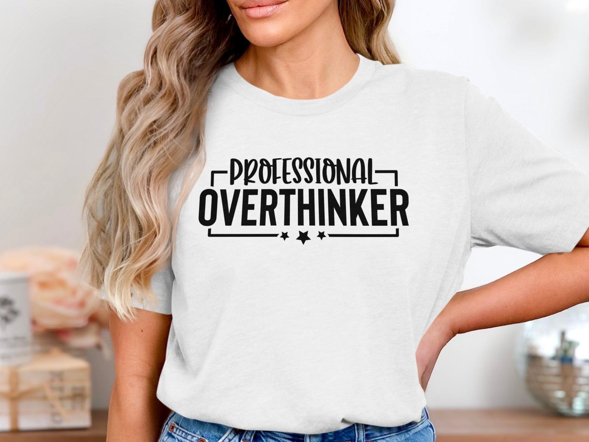 White t-shirt with black text reading "PROFESSIONAL OVERTHINKER" and two stars.