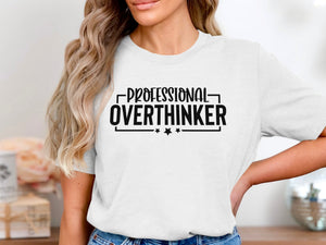 White t-shirt with black text reading "PROFESSIONAL OVERTHINKER" and two stars.