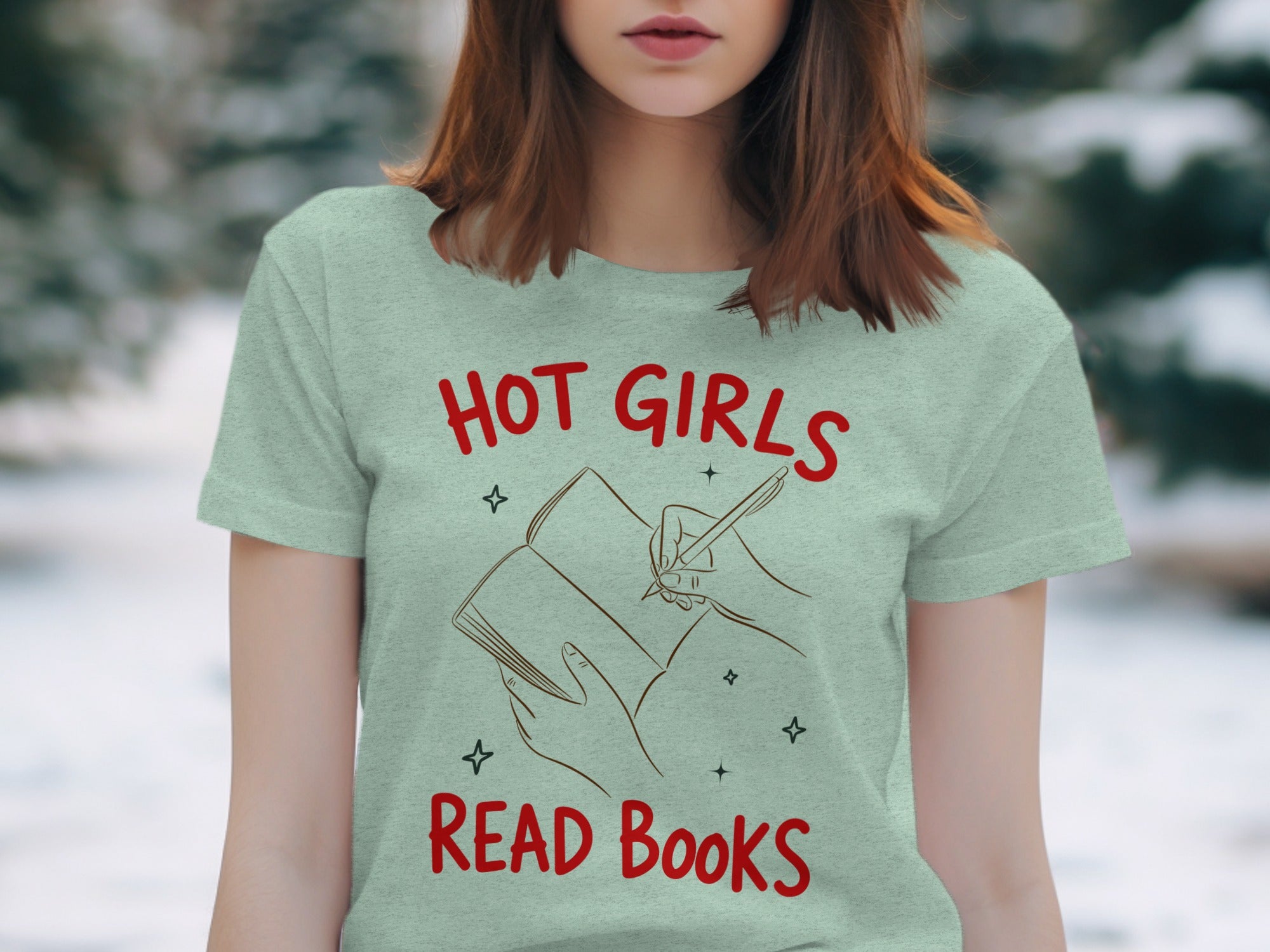 Mint t-shirt with red text "HOT GIRLS READ Books" and illustration of hands writing in a book.