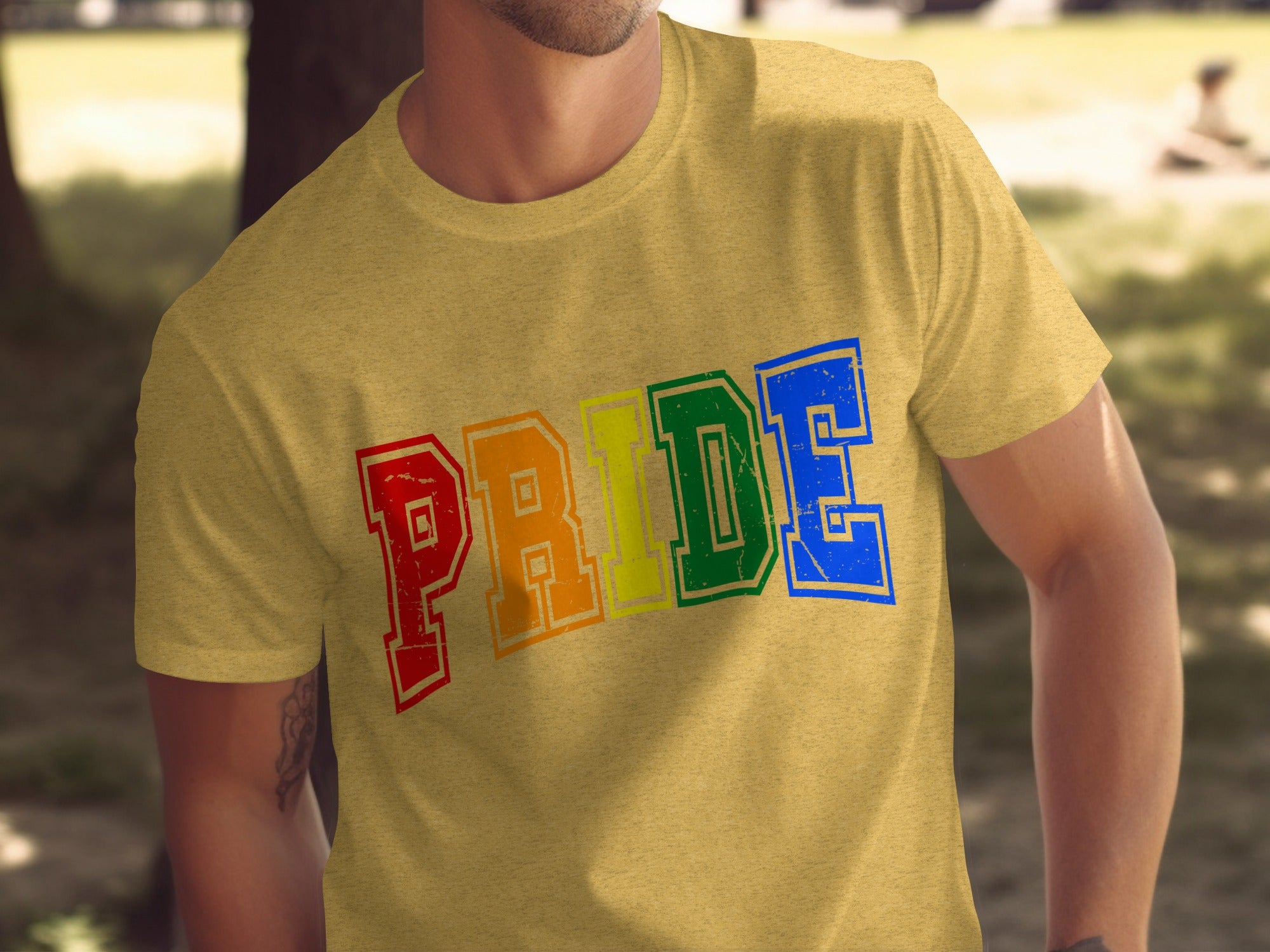 Yellow t-shirt with rainbow colored "PRIDE" text in distressed block letters.