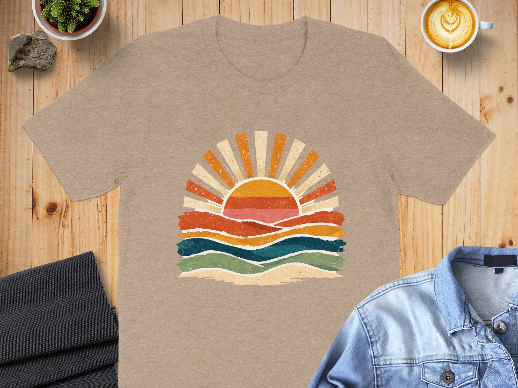 T-shirt with retro sunset graphic and rolling colorful hills.