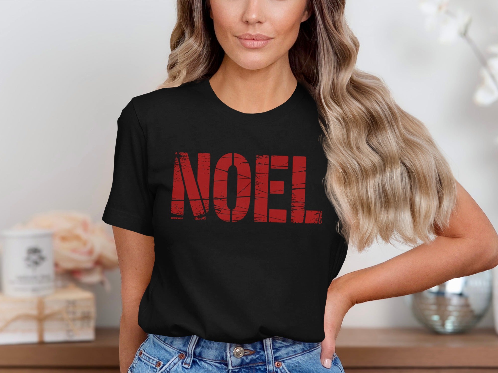Black t-shirt with distressed red "NOEL" text across the chest.