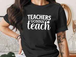 Black t-shirt with white text "Teachers Gonna Teach" and an apple graphic.