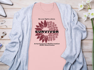 Pink t-shirt with "Survivor" text, sunflower design, and "AVM Awareness" slogan.
