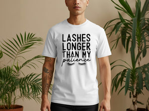 White t-shirt with black text reading "LASHES LONGER THAN MY patience" and eyelashes.