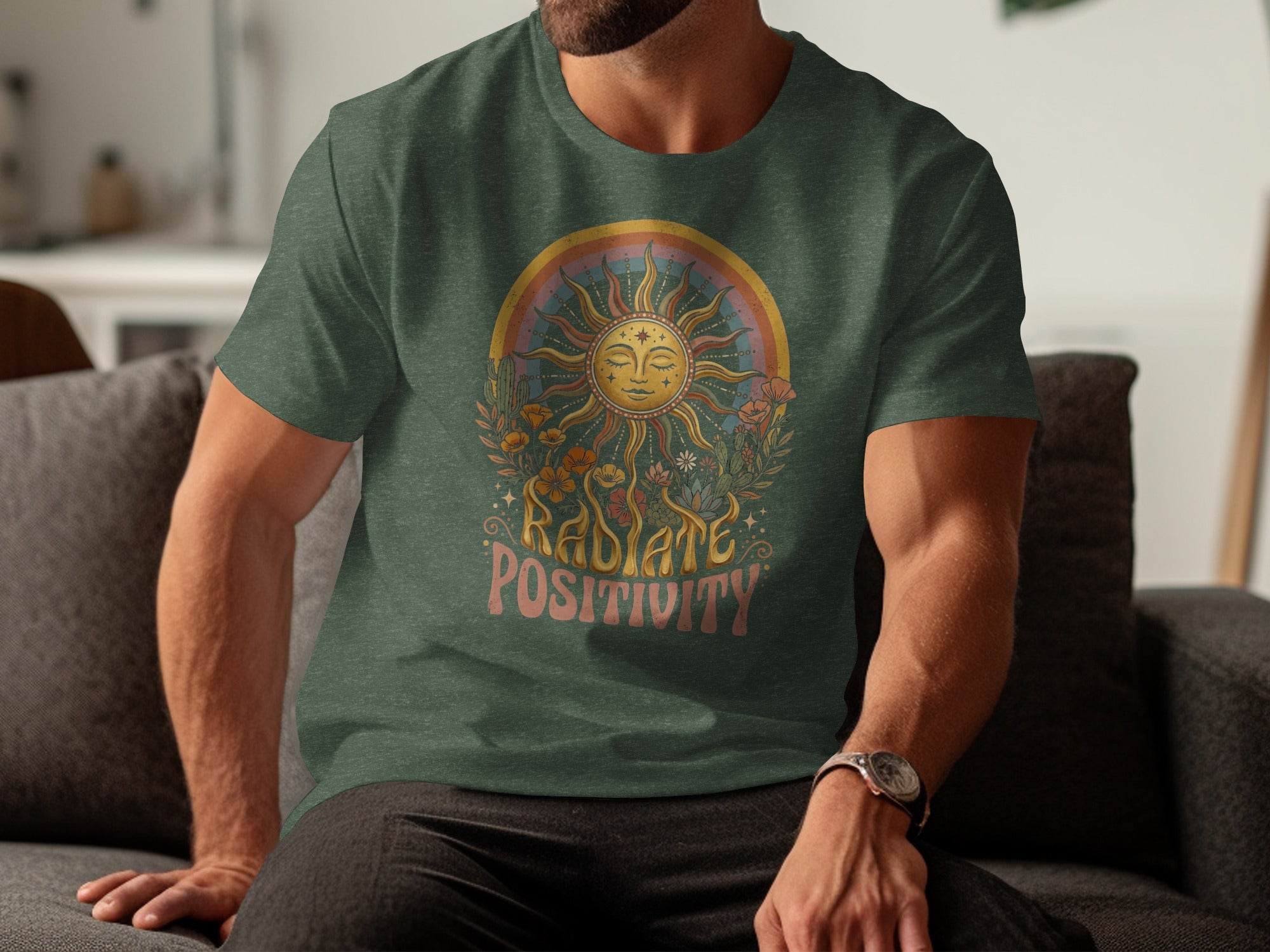 Green t-shirt with rainbow sun, flowers, cacti, and text "RADIATE POSITIVITY".