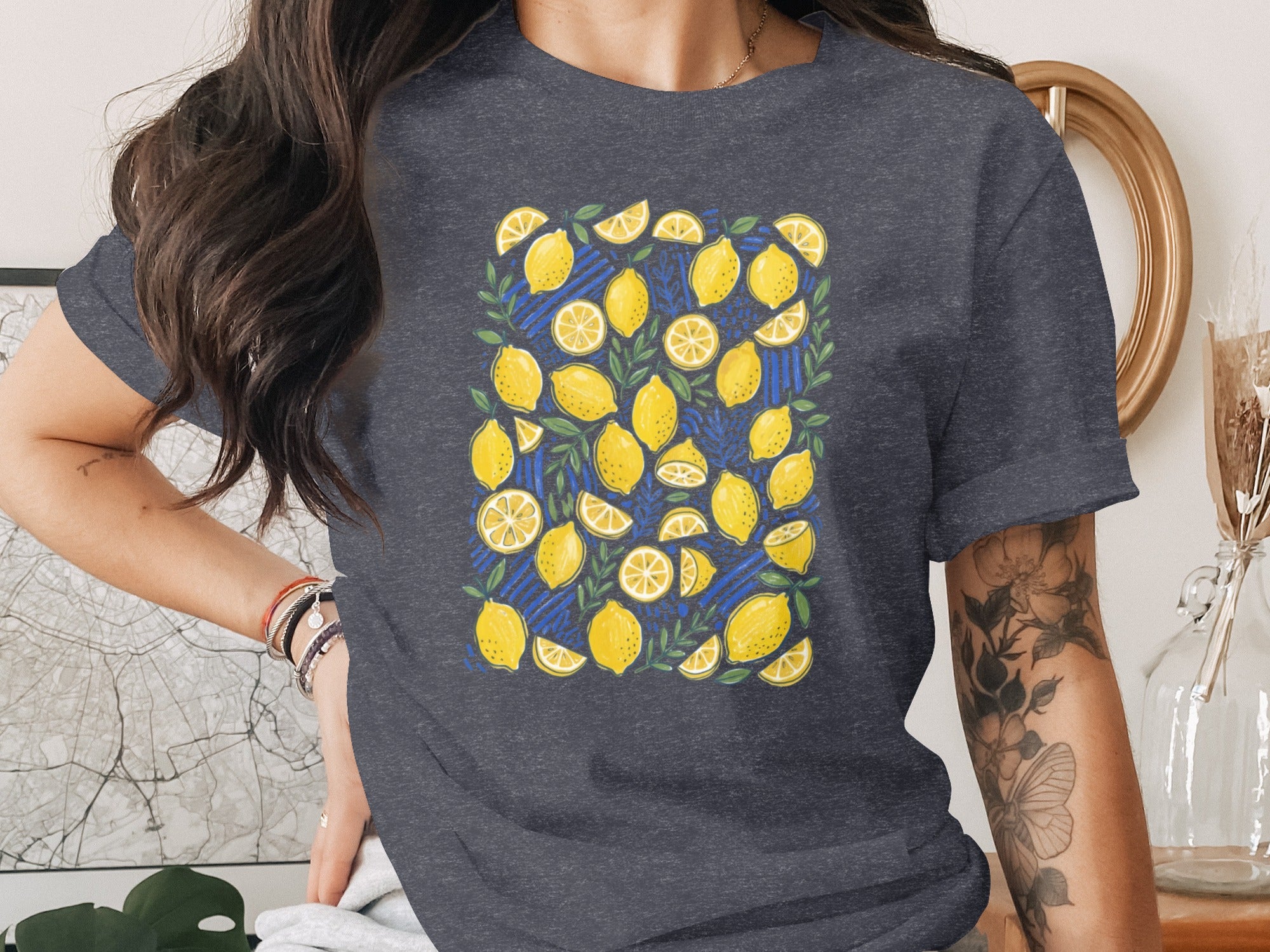 T-shirt with a repeating pattern of yellow lemons and green leaves.