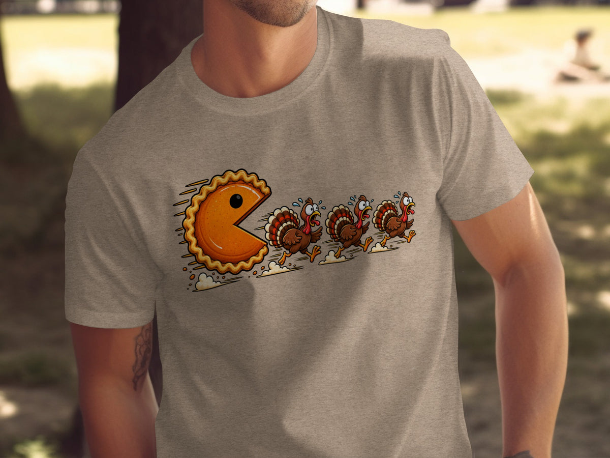 T-shirt graphic of a pie chasing scared turkeys in a Pac-Man style game.