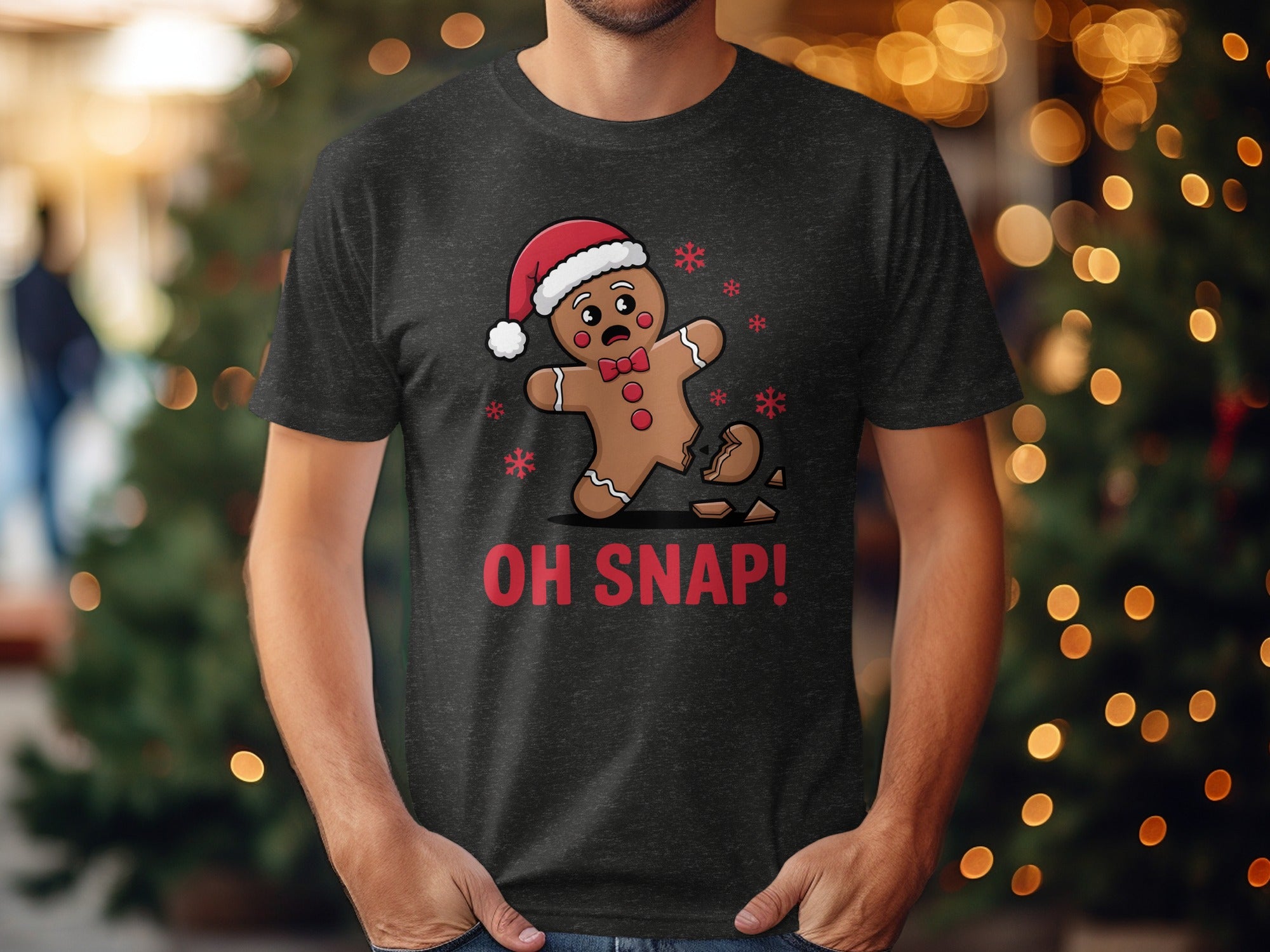 Dark t-shirt with a broken gingerbread man wearing a Santa hat and the text "OH SNAP!".