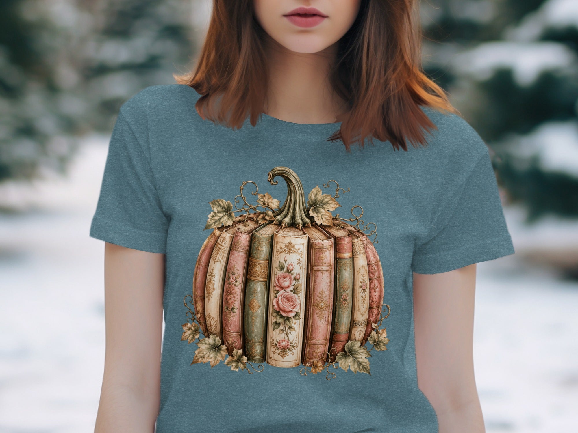 Pumpkin made of vintage books with roses and autumn leaves graphic on teal t-shirt.