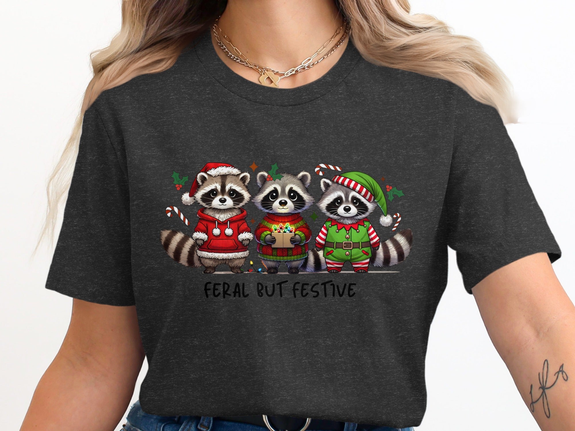 Three raccoons in festive holiday outfits with text "Feral But Festive".