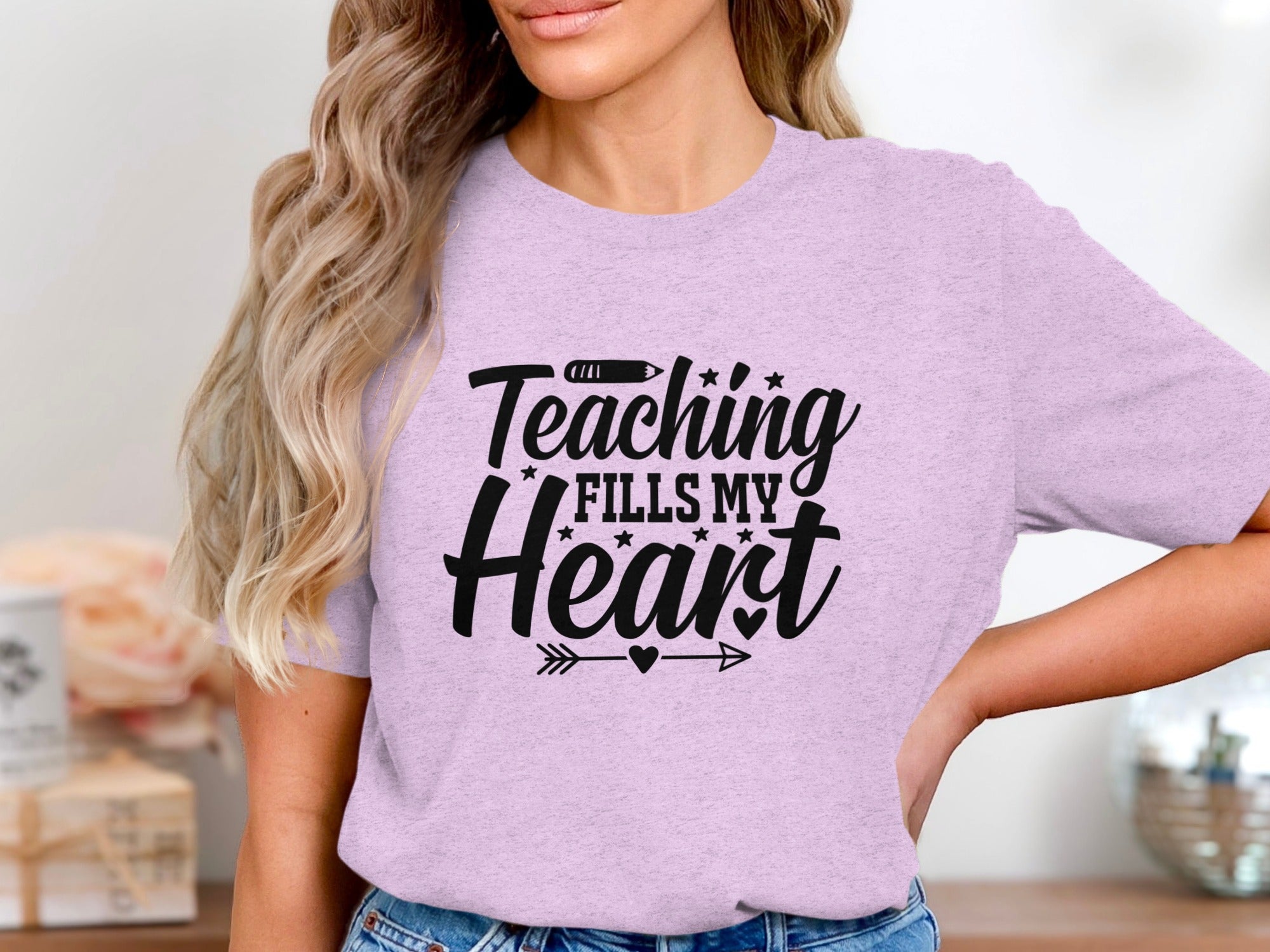 Lilac t-shirt with black text: "Teaching fills my heart".