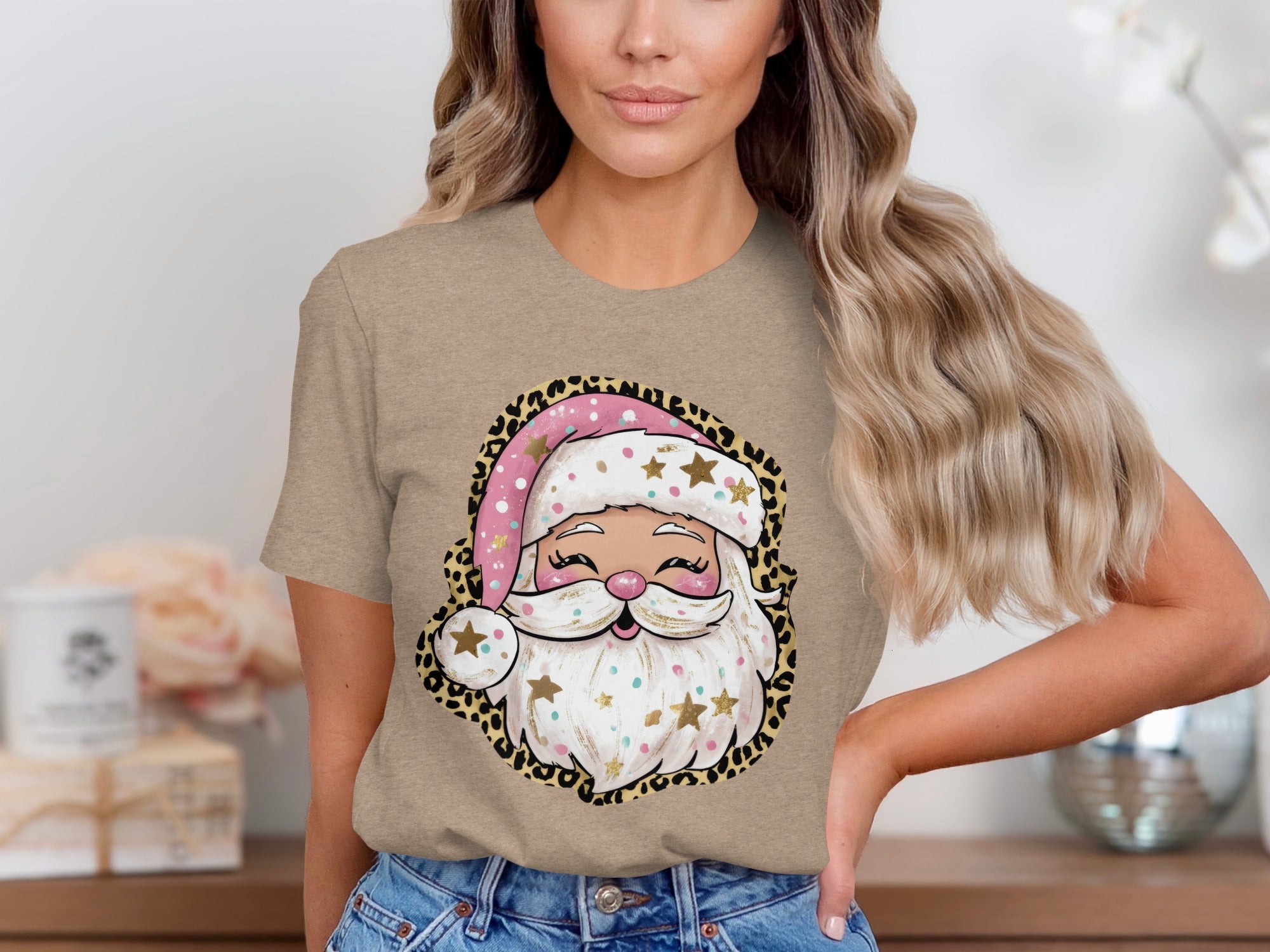 T-shirt with a cartoon Santa Claus graphic featuring a pink polka dot hat and leopard print border.