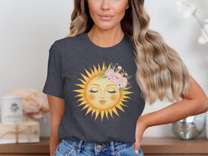 Dark grey t-shirt with a sun graphic wearing a floral crown and closed eyes.