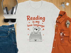 T-shirt with "Reading is my love language" text over stacked books and a coffee cup.