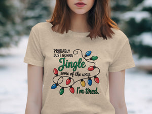 Light beige t-shirt with Christmas lights graphic and text.