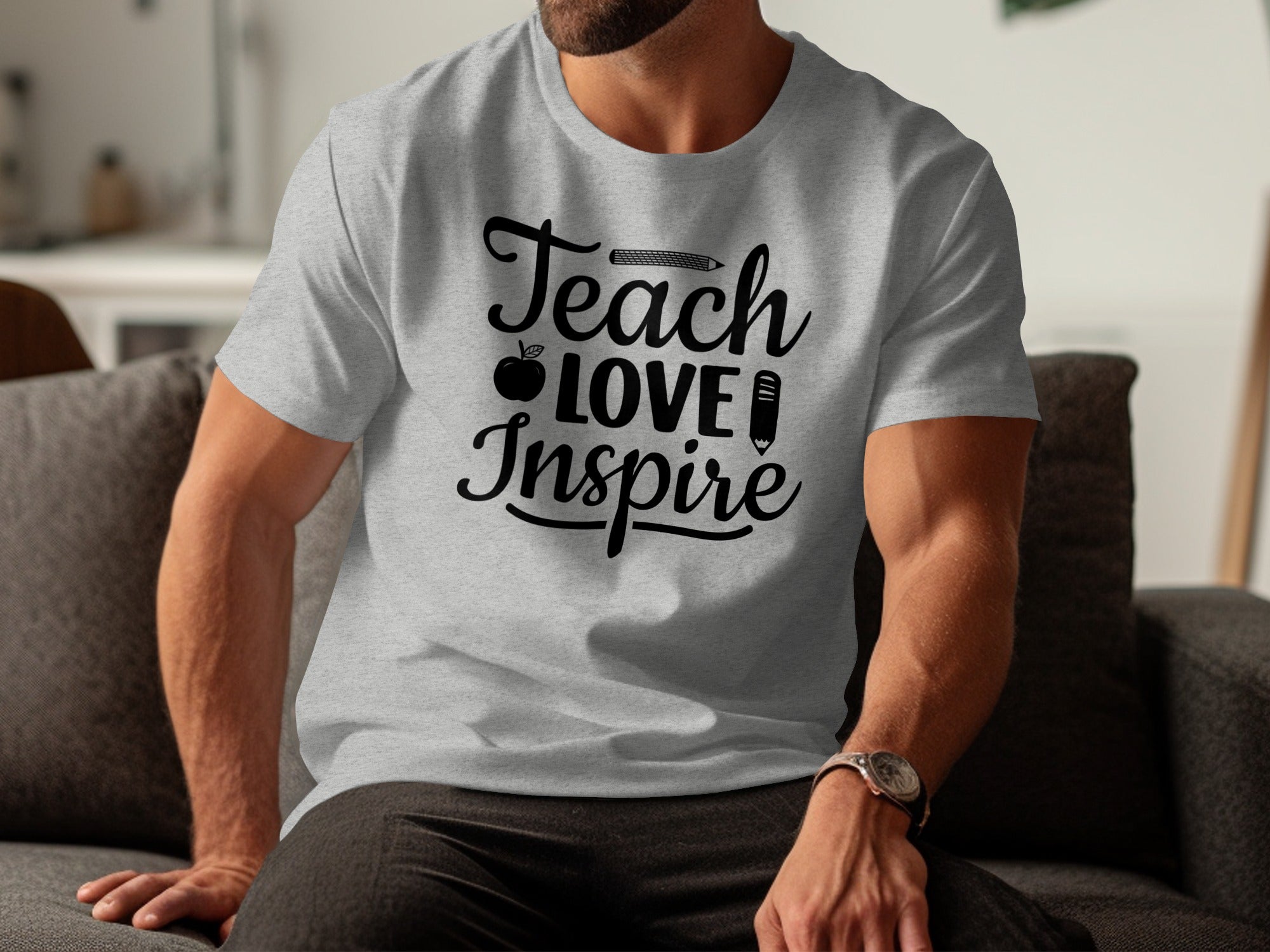 Grey t-shirt with black text "Teach Love Inspire" and teacher icons.