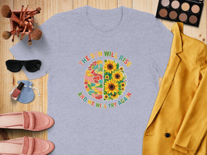 Grey t-shirt with colorful brain graphic, sunflowers, and text.