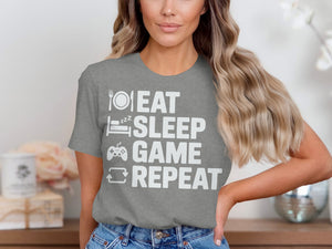 Grey t-shirt with white text: Eat, Sleep, Game, Repeat with icons.