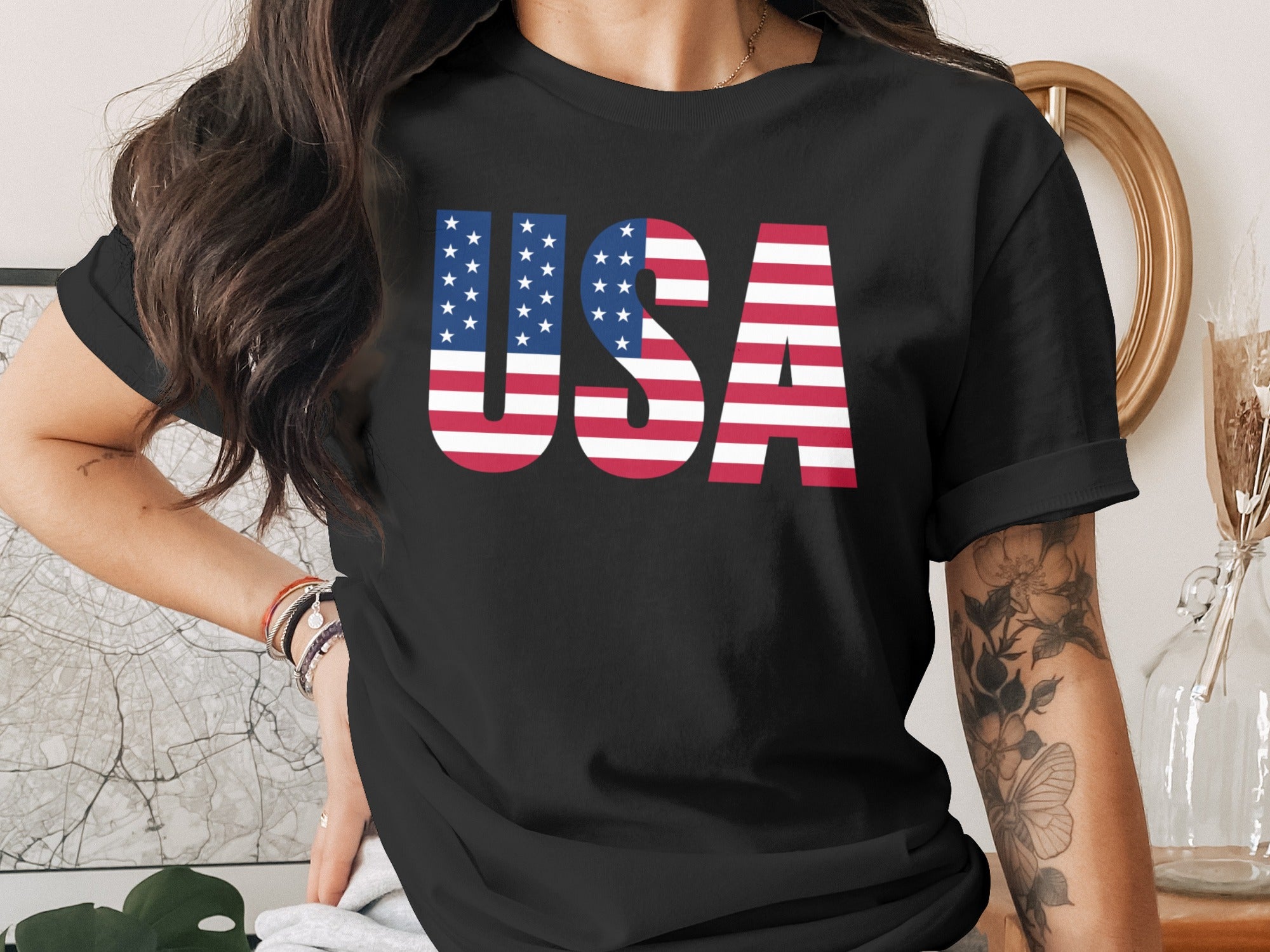 Black t-shirt with bold "USA" text in American flag design.