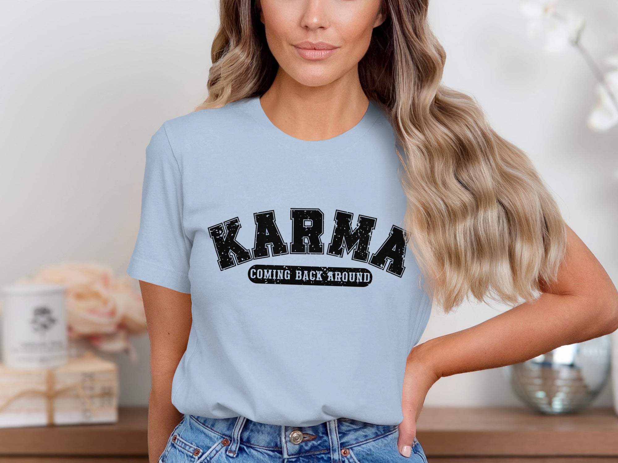 Light blue t-shirt with black text "KARMA COMING BACK AROUND".