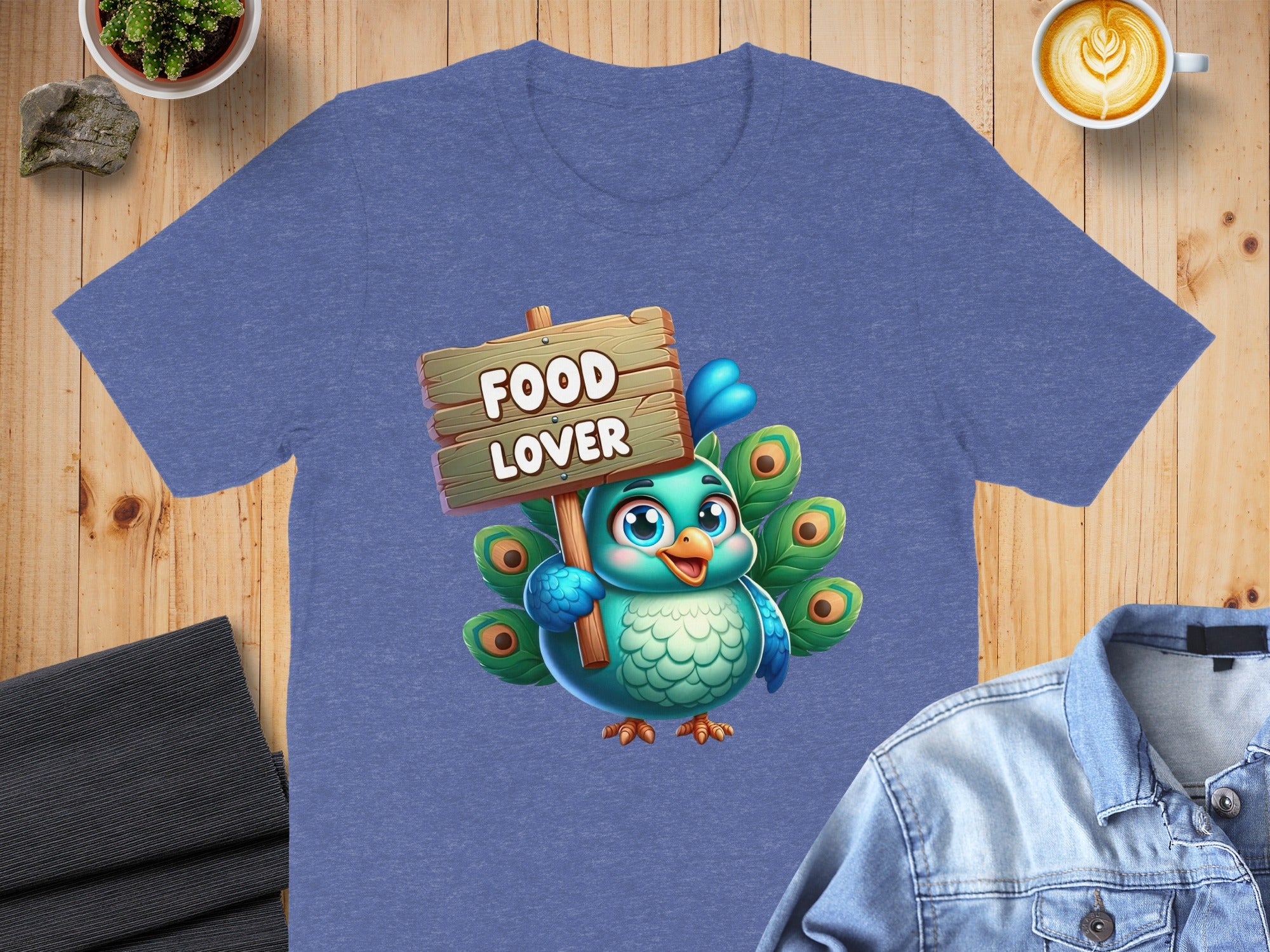 Blue t-shirt with cartoon peacock holding "Food Lover" sign.
