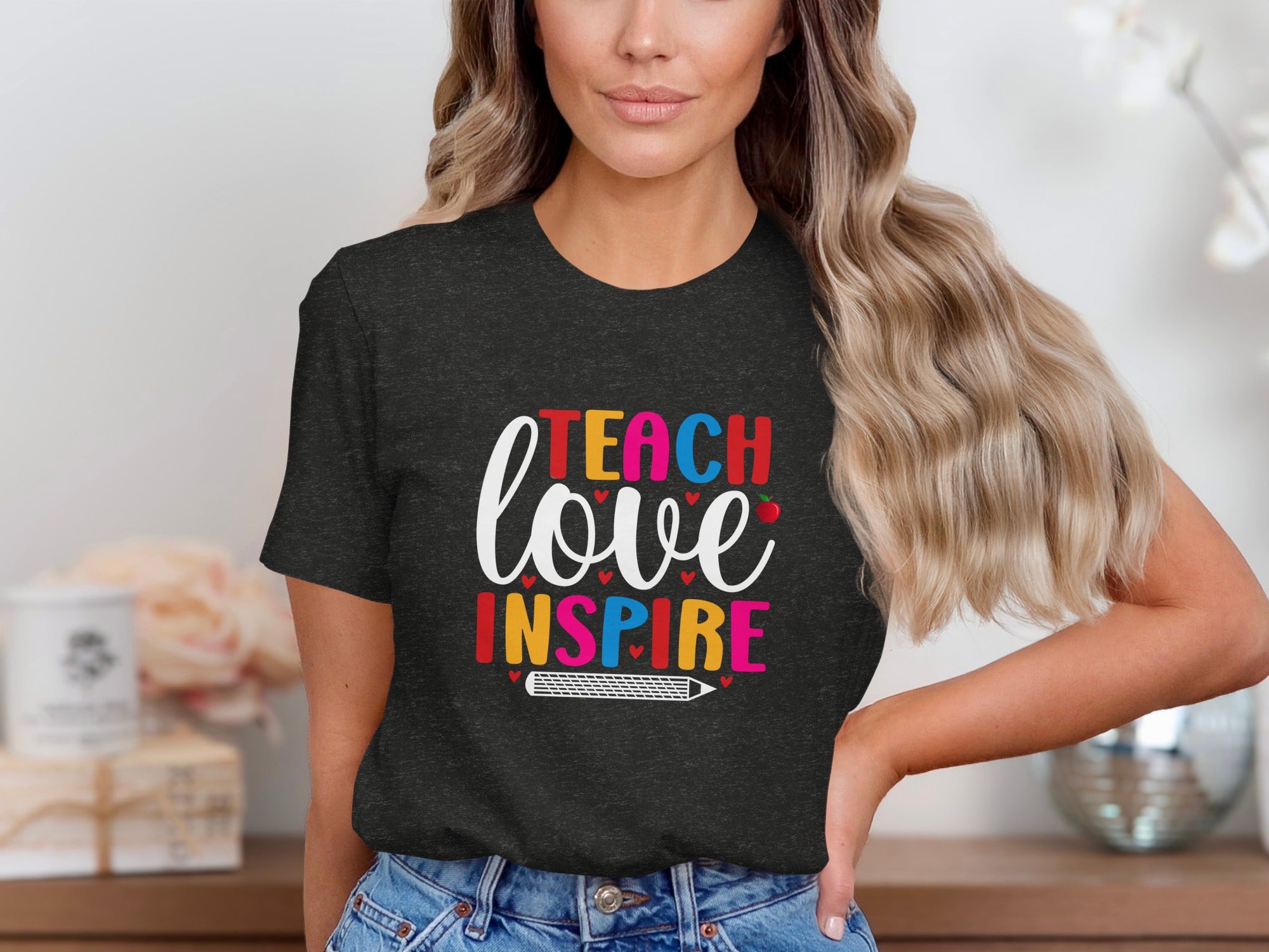 Dark t-shirt with "Teach love inspire" graphic and pencil design.