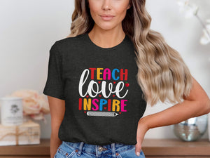 Dark t-shirt with "Teach love inspire" graphic and pencil design.