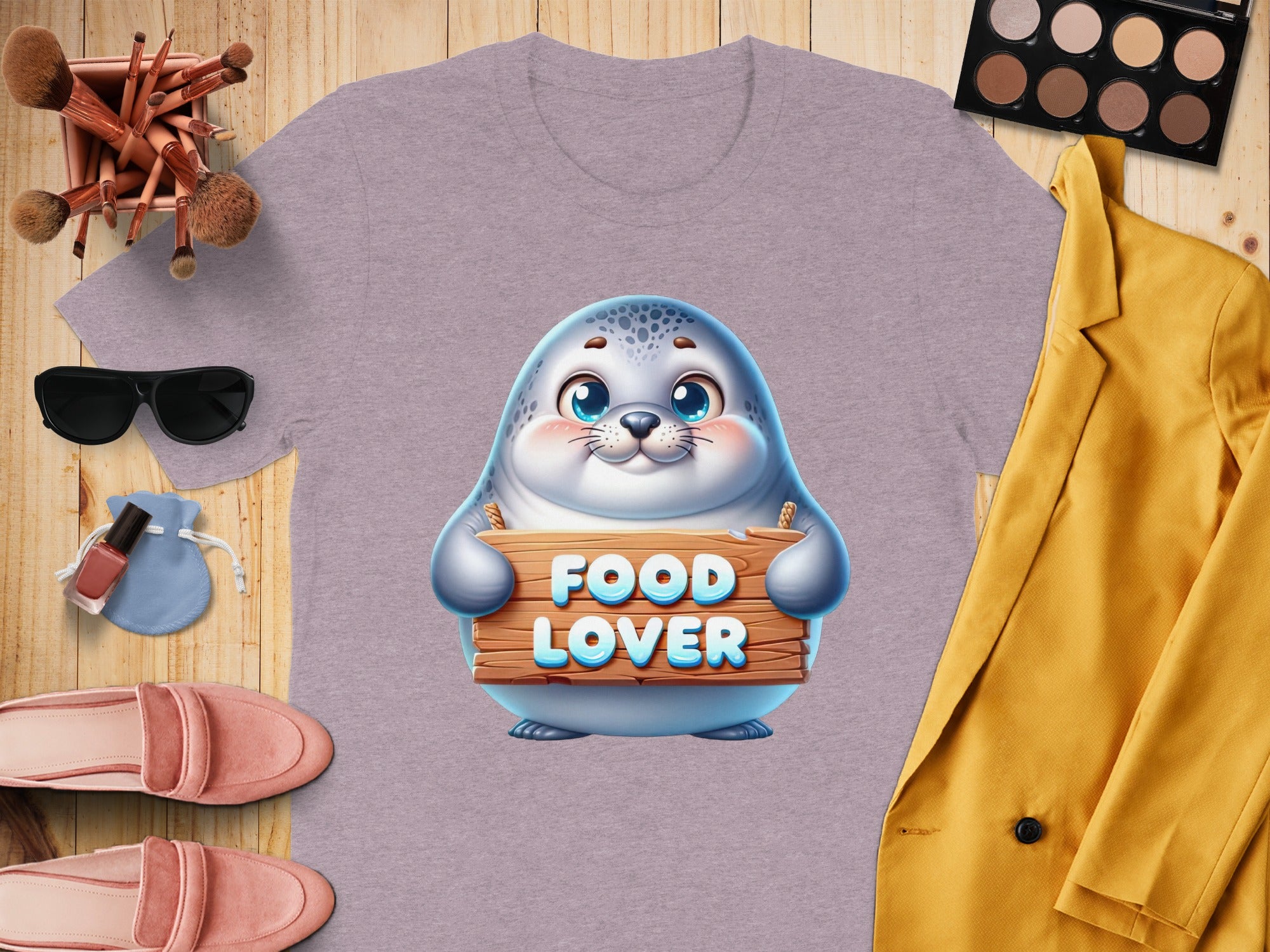 Lavender t-shirt with a seal graphic holding a "Food Lover" sign.