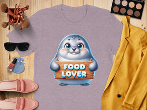 Lavender t-shirt with a seal graphic holding a "Food Lover" sign.