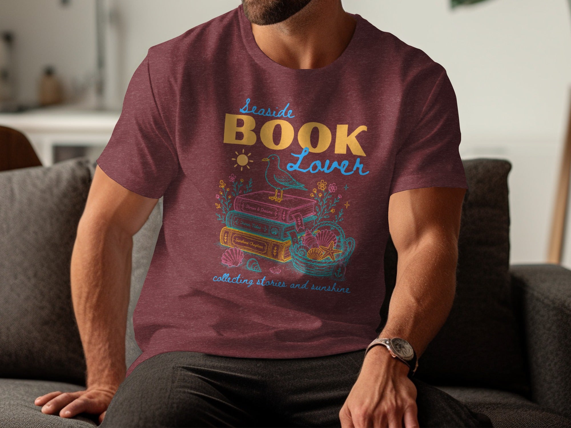 Maroon t-shirt with "Seaside Book Lover" text over stacked books and a beach scene.