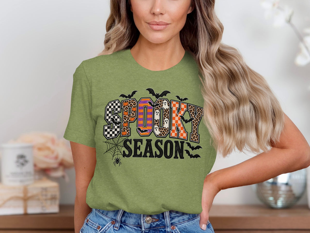 Green t-shirt with "SPOOKY SEASON" text featuring Halloween patterns and bats.