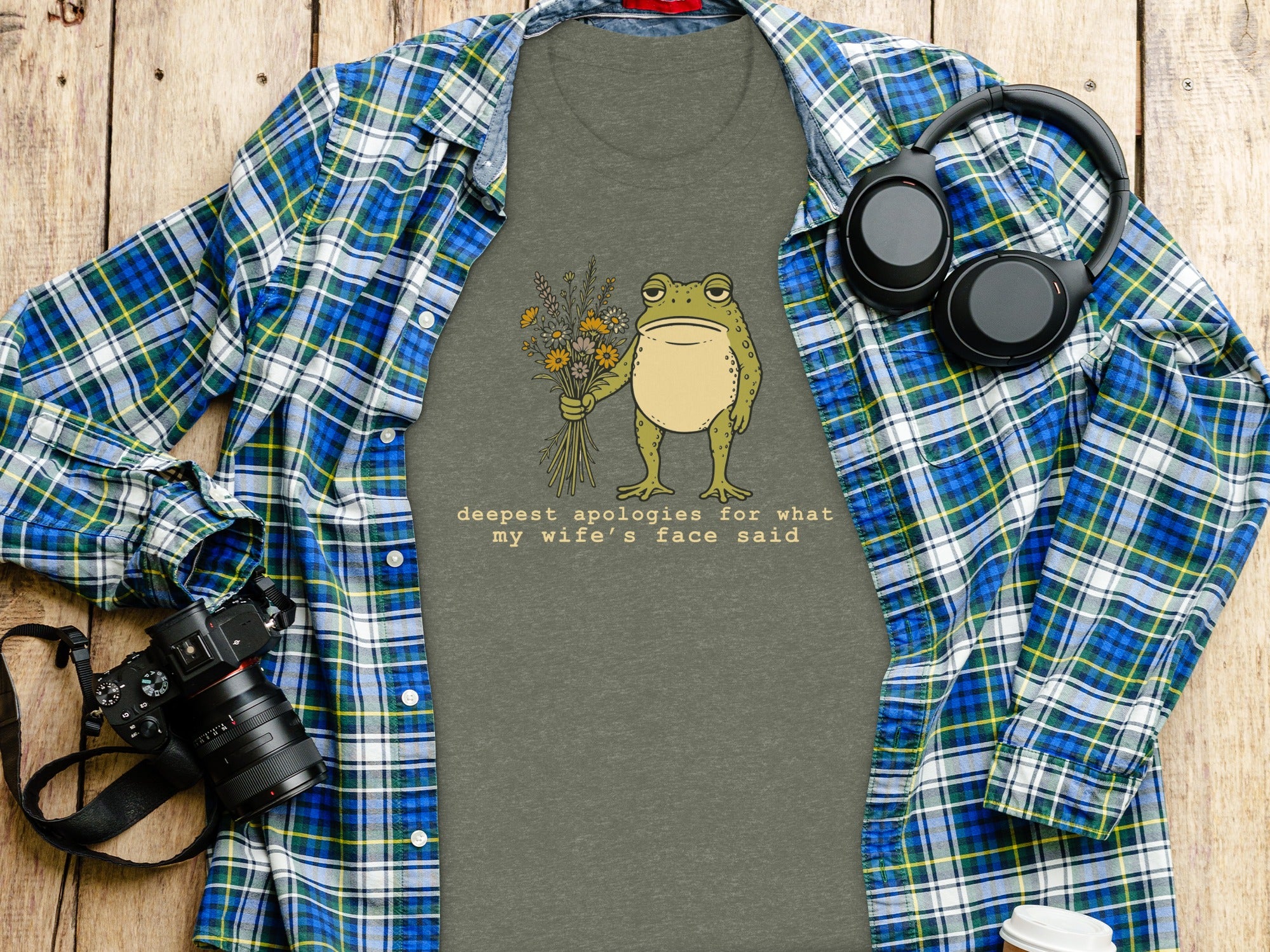 Gray t-shirt with cartoon frog holding flowers and text "deepest apologies for what my wife's face said".