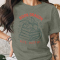 Green t-shirt with "BOOK DRAGON" and dragon sleeping on books graphic.