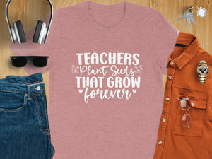 Pink t-shirt with white text "Teachers Plant Seeds That Grow forever"