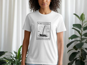 White t-shirt featuring black text and sailboat graphic: Port Haven Sailing Club est. 1973.