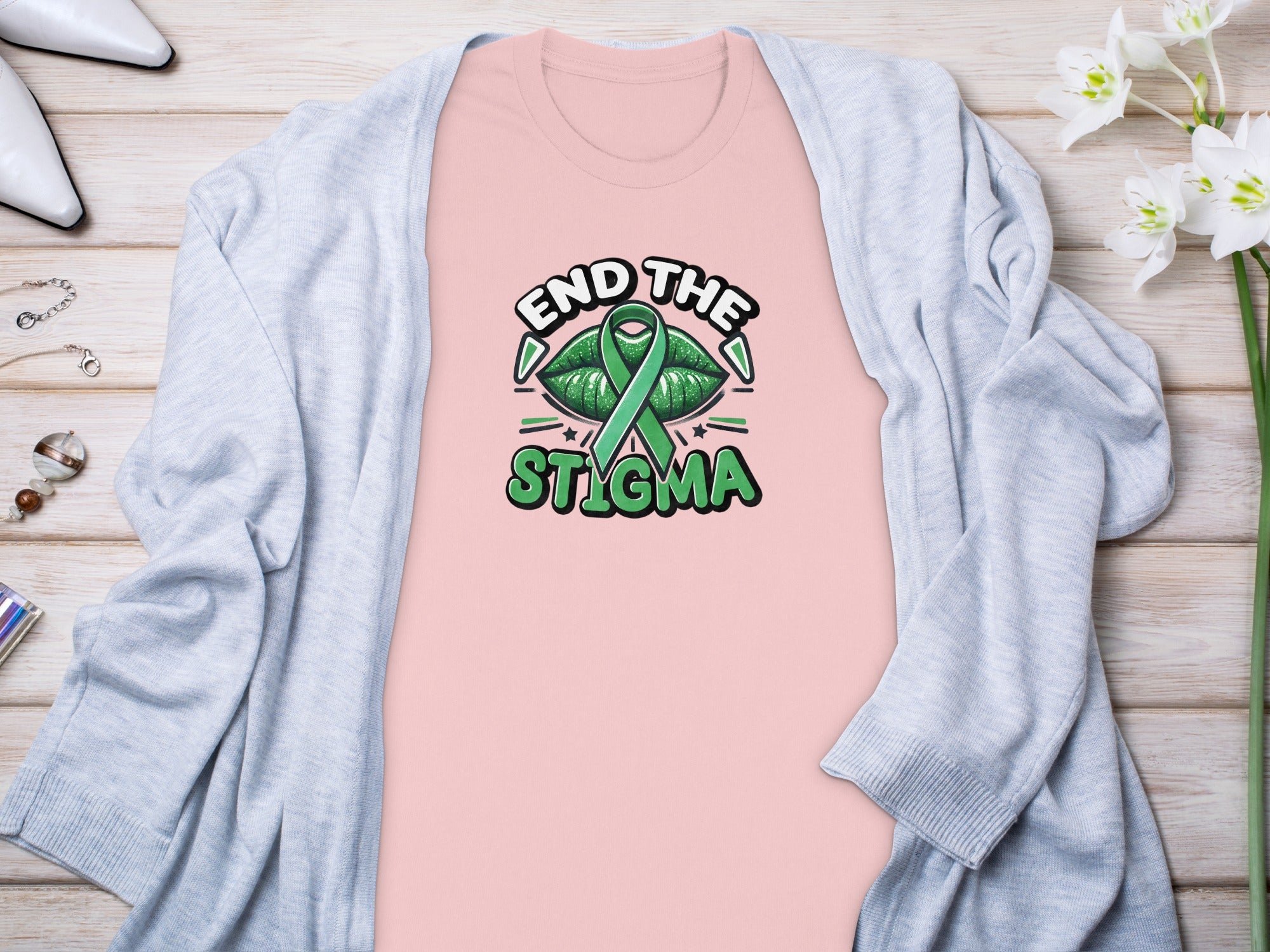 Pink t-shirt with green lips, ribbon, and text that says "End the Stigma."