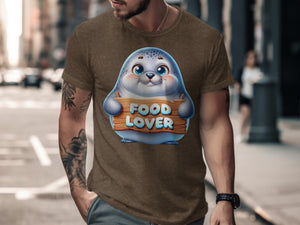 Brown t-shirt with a cute cartoon seal holding a sign that says "FOOD LOVER."