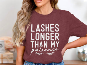 Burgundy t-shirt with "Lashes Longer Than My Patience" text and eyelashes graphic.
