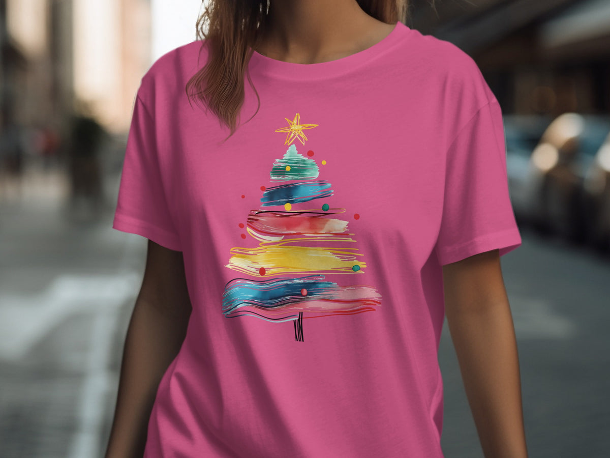 Pink t-shirt with abstract colorful Christmas tree graphic.