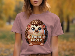 Illustration of a cartoon hedgehog holding a "FOOD LOVER" sign on a pink t-shirt.