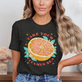 Dark t-shirt graphic with grapefruit, leaves, flowers, and text "TAKE YOUR VITAMIN SEA".