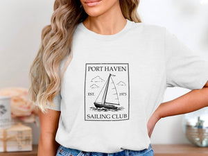 White t-shirt with black graphic: Port Haven Sailing Club est. 1973 sailboat design.
